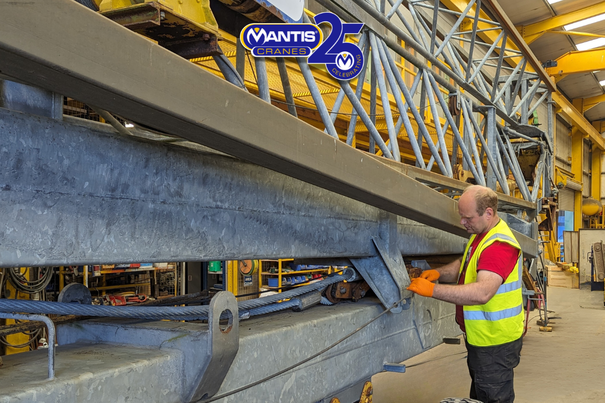 self erector rental A photo of the engineer checking a self-erecting crane during a service in the Mantis Cranes workshop.