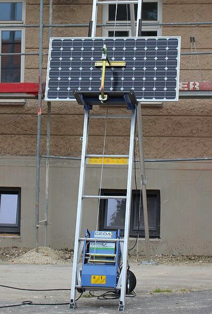 a photo of a solar panel being hoisted up on a geda inclined hoist