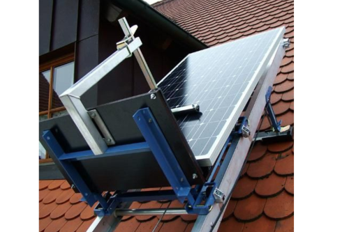 A photo of a solar panel being lifted on an inclined hoist