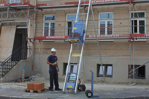 a photo of material being lifted with a rope hoist
